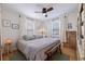 Relaxing bedroom featuring light hardwood floors, a ceiling fan, and a bench at the foot of the bed at 4426 3Rd N Ave, St Petersburg, FL 33713