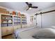 Well-appointed bedroom with a ceiling fan and custom storage cabinets and sliding barn doors at 4426 3Rd N Ave, St Petersburg, FL 33713
