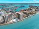 Breathtaking aerial view of the condominium highlighting prime waterfront location with beach and pools at 450 S Gulfview Blvd # 802, Clearwater Beach, FL 33767