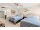 Bright bedroom featuring two beds, stylish decor, and a ceiling fan at 450 S Gulfview Blvd # 802, Clearwater Beach, FL 33767