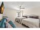 Comfortable bedroom featuring a sofa, two beds, and modern decor at 450 S Gulfview Blvd # 802, Clearwater Beach, FL 33767