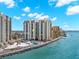 Gorgeous aerial view of a condominium building right on the water with pools and beach at 450 S Gulfview Blvd # 802, Clearwater Beach, FL 33767