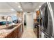 Updated kitchen with granite countertops, stainless steel appliances, and a breakfast bar overlooking the living area at 450 S Gulfview Blvd # 802, Clearwater Beach, FL 33767