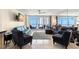 Bright living room with ocean views from the balcony, comfortable seating, and neutral decor at 450 S Gulfview Blvd # 802, Clearwater Beach, FL 33767
