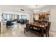 Bright and airy living room with ocean views, a dining area, and access to modern kitchen at 450 S Gulfview Blvd # 802, Clearwater Beach, FL 33767