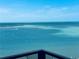 Stunning ocean view from the balcony with boats cruising on turquoise waters under a clear sky at 450 S Gulfview Blvd # 802, Clearwater Beach, FL 33767