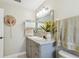 Bathroom with a decorative mirror above the vanity and cabinet and a hat hanging on the wall for decor at 4606 Copper Ln, Plant City, FL 33566