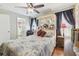 Comfortable bedroom featuring a ceiling fan and a decorated headboard with an attached mirror above the bed at 4606 Copper Ln, Plant City, FL 33566