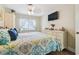Comfortable bedroom featuring a TV, dresser, and natural lighting at 4606 Copper Ln, Plant City, FL 33566