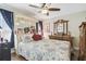Bedroom featuring a large bed with a decorative headboard and vintage wood dresser at 4606 Copper Ln, Plant City, FL 33566