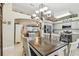 Open dining area with stylish chandelier and view into the kitchen and living room at 4606 Copper Ln, Plant City, FL 33566