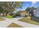 A well maintained home with a tidy lawn, mature trees, and a concrete driveway at 4606 Copper Ln, Plant City, FL 33566