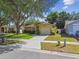 Home featuring well-maintained landscaping, mature trees, and a concrete driveway at 4606 Copper Ln, Plant City, FL 33566