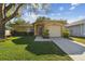 Charming home with a well-manicured lawn and mature tree providing shade at 4606 Copper Ln, Plant City, FL 33566