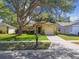 Charming home with a well-manicured lawn and mature tree providing shade at 4606 Copper Ln, Plant City, FL 33566