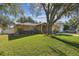 Charming home with a well-manicured lawn and mature tree providing shade at 4606 Copper Ln, Plant City, FL 33566