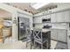 Modern kitchen featuring stainless appliances, stylish gray cabinets, and an island with seating at 4606 Copper Ln, Plant City, FL 33566