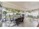 Screened porch furnished with a dining set and rocking chairs, offering a serene space for relaxation at 4606 Copper Ln, Plant City, FL 33566