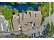 A beautiful aerial view of a condo with a pond, fountain, parking, and landscaping at 4611 Duhme Rd # 1A, St Petersburg, FL 33708