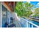 Balcony overlooking a lake featuring a fountain, green trees, and seating at 4611 Duhme Rd # 1A, St Petersburg, FL 33708