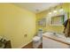 Comfortable half bathroom features wood-look flooring, single sink vanity, and neutral decor at 4611 Duhme Rd # 1A, St Petersburg, FL 33708