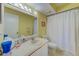 Clean bathroom with updated vanity, lighting, and shower/tub combo with white curtain at 4611 Duhme Rd # 1A, St Petersburg, FL 33708