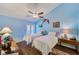 Well-lit bedroom features two cozy beds, wood-look floors, and overhead fan at 4611 Duhme Rd # 1A, St Petersburg, FL 33708