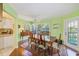 Bright dining area with hardwood floors, natural light, a ceiling fan, and a full dining set at 4611 Duhme Rd # 1A, St Petersburg, FL 33708