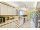 Bright kitchen with stainless steel appliances and view to outdoor dining area and pool at 4611 Duhme Rd # 1A, St Petersburg, FL 33708