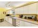 Bright kitchen features white cabinetry, stainless steel dishwasher, and stylish countertops at 4611 Duhme Rd # 1A, St Petersburg, FL 33708