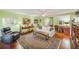 Living room features a comfortable recliner, white couch, hardwood floors and neutral tones at 4611 Duhme Rd # 1A, St Petersburg, FL 33708