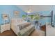 Comfortable main bedroom with vaulted ceiling, sliding glass doors to balcony and neutral tones at 4611 Duhme Rd # 1A, St Petersburg, FL 33708