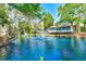 Beautiful pond view featuring a fountain, lush greenery, and the building's screened porch at 4611 Duhme Rd # 1A, St Petersburg, FL 33708