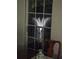 A window view of an outdoor fountain at night with a vase and chair inside the home at 4611 Duhme Rd # 1A, St Petersburg, FL 33708