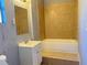 Bathroom with tiled shower and bathtub, vanity sink and standard mirror at 5211 Jersey S Ave, Gulfport, FL 33707