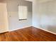 Bedroom features hardwood floors, a window, and neutral paint at 5211 Jersey S Ave, Gulfport, FL 33707