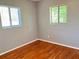 Bedroom featuring hardwood floors and two windows offering natural light at 5211 Jersey S Ave, Gulfport, FL 33707
