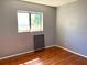 Bedroom with hardwood floors and a large window offering natural light at 5211 Jersey S Ave, Gulfport, FL 33707