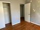 Bedroom featuring hardwood floors, closet, and a white door at 5211 Jersey S Ave, Gulfport, FL 33707