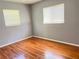 Bedroom with hardwood floors and two windows with natural light at 5211 Jersey S Ave, Gulfport, FL 33707