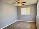 Bedroom with a ceiling fan, carpeted floors, and a window with blinds at 5211 Jersey S Ave, Gulfport, FL 33707