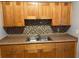 Kitchen cabinets with mosaic backsplash and a stainless steel double sink at 5211 Jersey S Ave, Gulfport, FL 33707