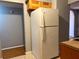 A kitchen featuring a white refrigerator, wood cabinets, and gray walls at 5211 Jersey S Ave, Gulfport, FL 33707