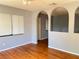Open-concept living room with hardwood floors and arched architectural features at 5211 Jersey S Ave, Gulfport, FL 33707