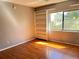 Living room features hardwood floors, a built-in bookcase, and great natural light at 5211 Jersey S Ave, Gulfport, FL 33707
