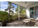 View of the palm trees and a pond from a screened in porch at 5460 Sandy Shell Dr, Apollo Beach, FL 33572