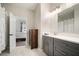 Bathroom boasts gray vanity cabinets, white countertop, a large mirror, and marble floors at 5460 Sandy Shell Dr, Apollo Beach, FL 33572