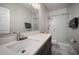 Modern bathroom with a stone countertop, a glass-enclosed shower, and sleek fixtures at 5460 Sandy Shell Dr, Apollo Beach, FL 33572