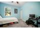 Bright blue bedroom featuring a computer desk and a window overlooking palm trees at 5460 Sandy Shell Dr, Apollo Beach, FL 33572