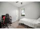 A basic bedroom with a bed, computer desk, and black and red chair at 5460 Sandy Shell Dr, Apollo Beach, FL 33572